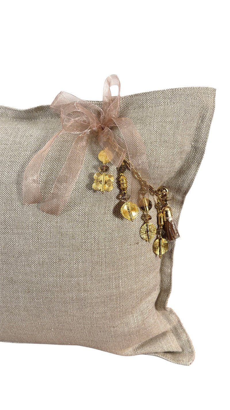 Détail coussin lin beige avec poids Ashanti et coquillages – MIYA