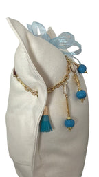 Coussin ZANZIBAR No.57 en lin lourd blanc et pampille turquoise artisanale.