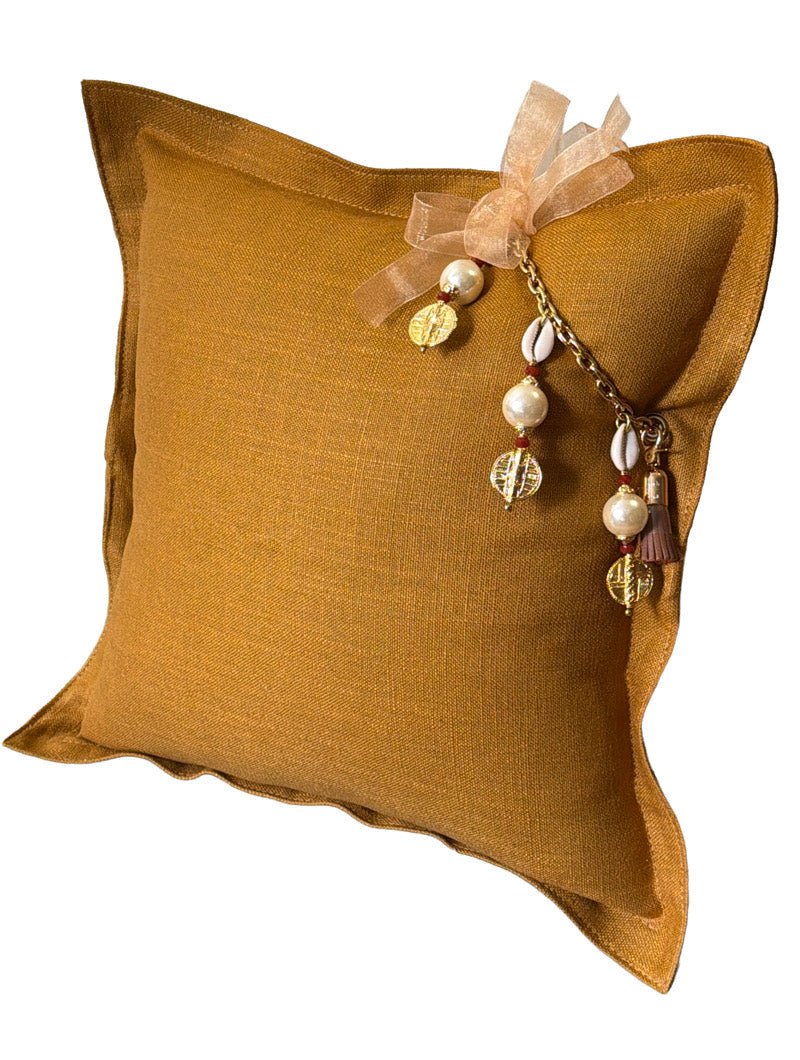 Coussin décoratif en lin lourd moutarde MIYA avec pampille Marrakech No.51, cauris et perles nacrées. Fabrication artisanale française au style bohème chic.
